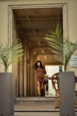 Young woman walking happily on the streets of Bucharest