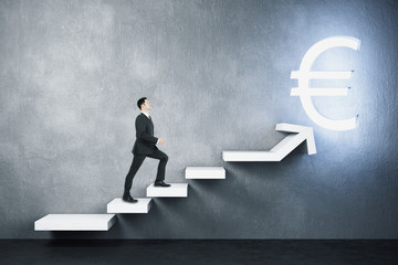 Businessman climbs stairs to a glowing euro sign