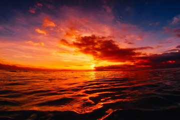 Quiet sea with warm sunset or sunrise colors. Bright sky and ocean