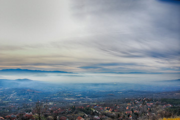 Environment pollution, foggy landscape of valley. Fog and pollution above the city of Nis, You can't see the city from smog