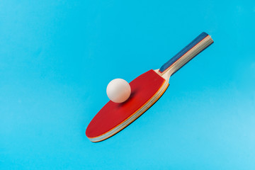 Red ping pong racket on a blue background