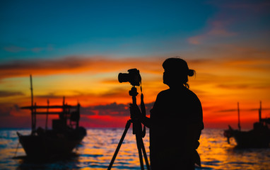 Fototapeta premium Silhouette of photographer with sunset time.