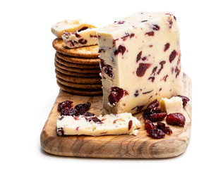 Cranberry cheddar cheese with wheat crackers isolated on white