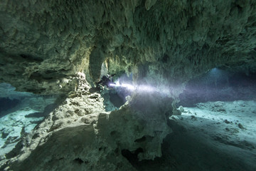 A DPV cave diver swims in the Chan hal cenote (Mexico)