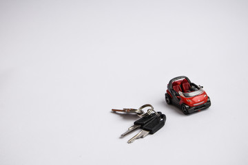 toy car and keys on the white background place for text