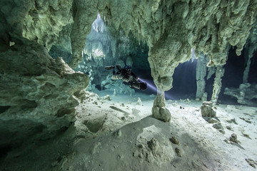 A DPV cave diver swims in the Chan hal cenote (Mexico)