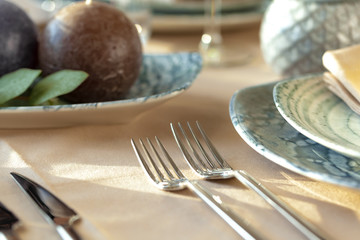 Silver cutlery on table top with tablecloth