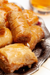 Stacked turkish baklava dessert in a plate close up