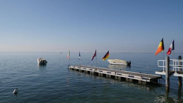 Boats and Flags on Garda Lake, Italy. Bardolino bay area