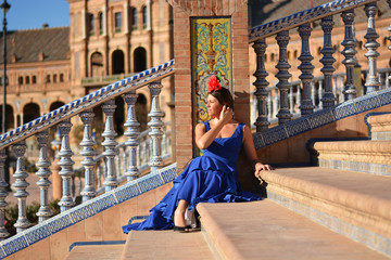 the flamenco dancer sitting on the steps - obrazy, fototapety, plakaty