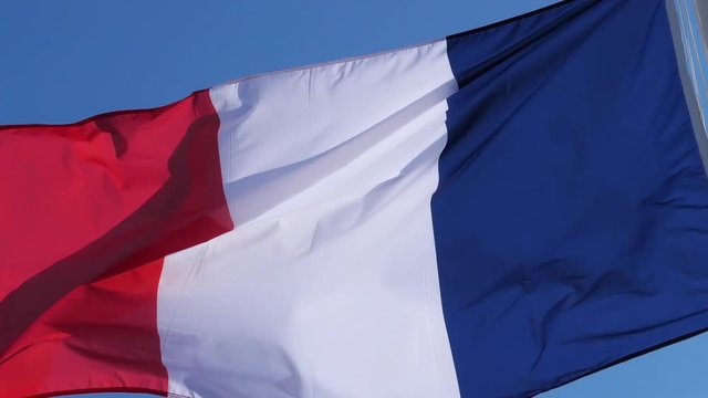 The french national flag waving inthe wind.
