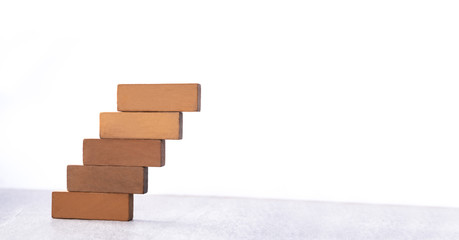 Wooden block stack as staircase isolated on white background with copy space, growth business development success process concept