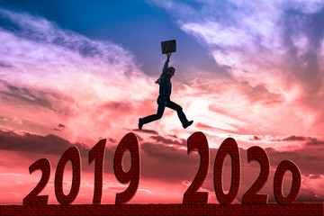 Businessman jump between 2019 and 2020 years.