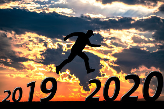 Businessman jump between 2019 and 2020 years.