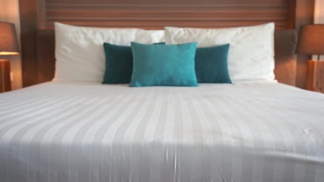 Tilt-up from the foot of a resort bed to the colorful headboard.