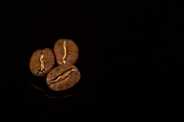 Coffee beans. Black background. Space for text. Close-up.
