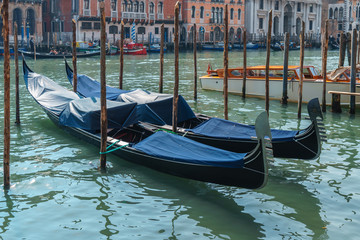 Fototapeta na wymiar Canal with gondolas in Venice, Italy. Postcard with Venice gondolas.
