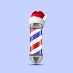 Barber pole With a hat of Santa Claus. Isolated on a blue background. Beauty and fashion