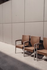 Minimalistic chairs against the gray wall 