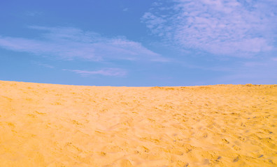 Beautiful flat desert landscape. Lots of sand and blue sky.