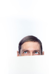 The person's face is covered with a white piece of paper, on an isolated background.