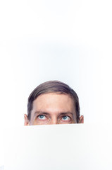 The person's face is covered with a white piece of paper, on an isolated background.
