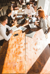 A team of young businessmen working and communicating together in an office. Corporate businessteam...