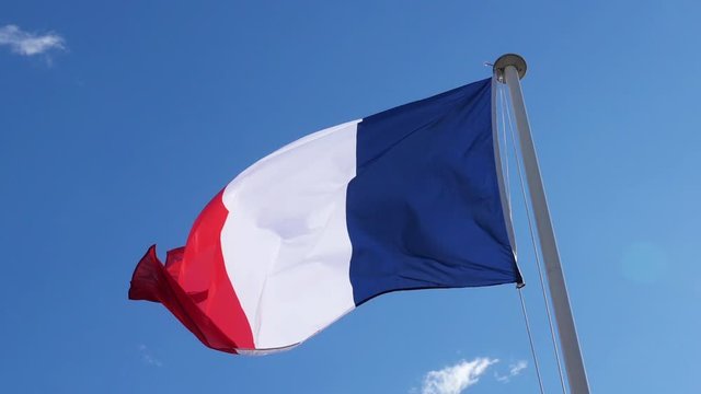 The french national flag waving inthe wind.