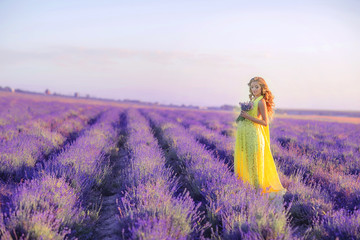 Woman with a bouquet in a field of young lavender on a spring day.