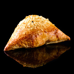 Uzbek samsa from tandoor on a black background