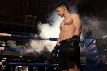 muscular sporty man after active fight with opponent. kickboxer in fight, combative man with naked...