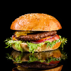 fast food juicy burger on a black background