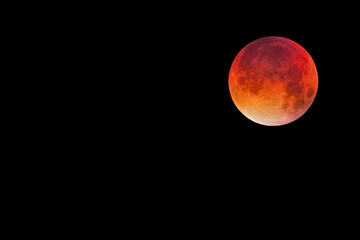 Bloody moon, full moon against black sky background, copy space to the left
