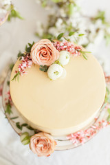 White wedding cream cheese cake with flowers decorations. Engagement party cake, anniversary cake, birthday cake