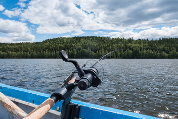 Rod and reel on boat railing trolling