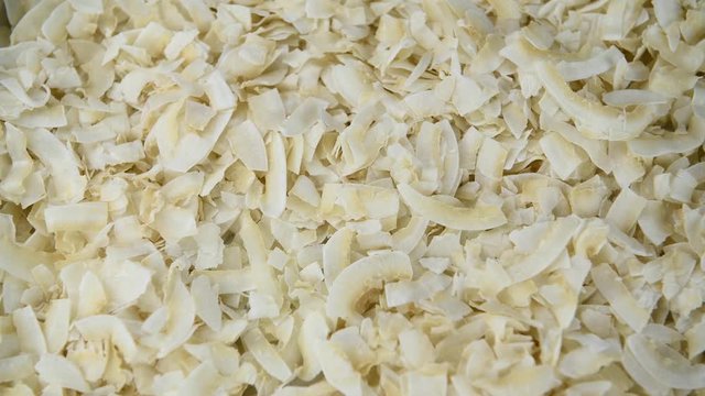 Portion of crispy Coconut Chips rotating on a plate (seamless loopable; 4K)