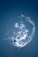 Water splashing on Ice cubes isolated over a blue background and copy space