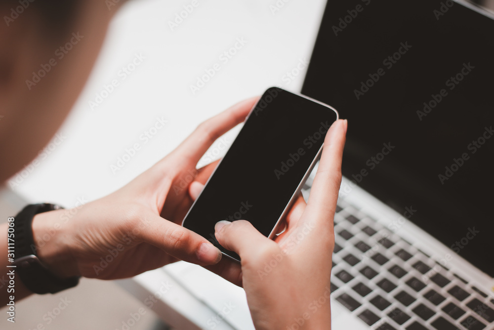 Aufkleber woman's hands are using a smartphone at home.smartphone with empty screen for design.