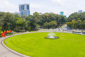Green lawn and fountain in front of Reunification Palace in Ho Chi Minh City, Vietnam