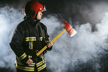 caucasian fireman hero, ready to protect all humanity from fire, professional firefighter in protective uniform