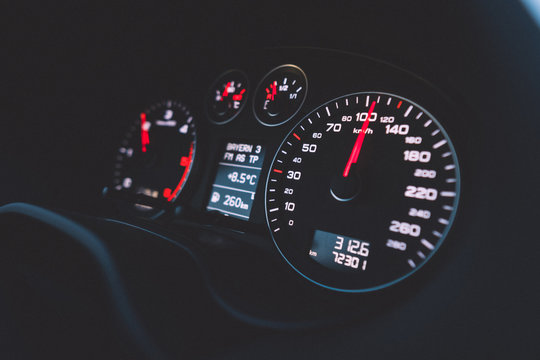 Close up shot of a speedometer in a car. Car dashboard. Dashboard details with indication lamps.Car instrument panel. Dashboard with speedometer, tachometer, odometer. Car detailing.