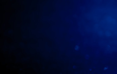 blue Abstract glitter bokeh on black background