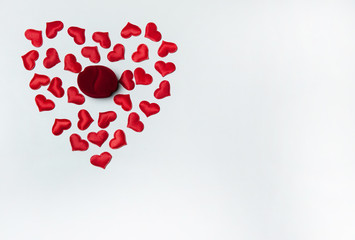 The Concept Of Valentine's Day. Velvet jewelry gift box and red hearts on white background. Free space for your text.