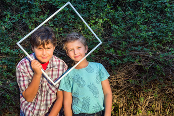 Two brothers looking through frame