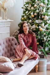 Girl on the background of the Christmas tree. happy young woman celebrating Christmas