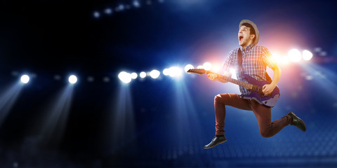Obraz premium Guitarist at concert. Mixed media