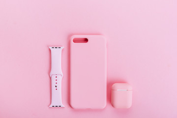 Up to date technology.Top view of diverse personal accessory laying on the pink background