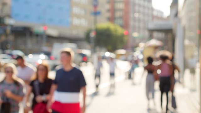 Urban dynamic scenery on Houston Street New York City, unrecognizable fashionable young people walking, bright summer day, slow motion