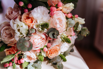 Wedding flowers, bridal bouquet closeup. Decoration made of roses, peonies and decorative plants
