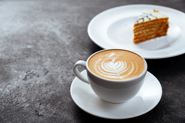 cup of coffee and cake on black stone background Top view